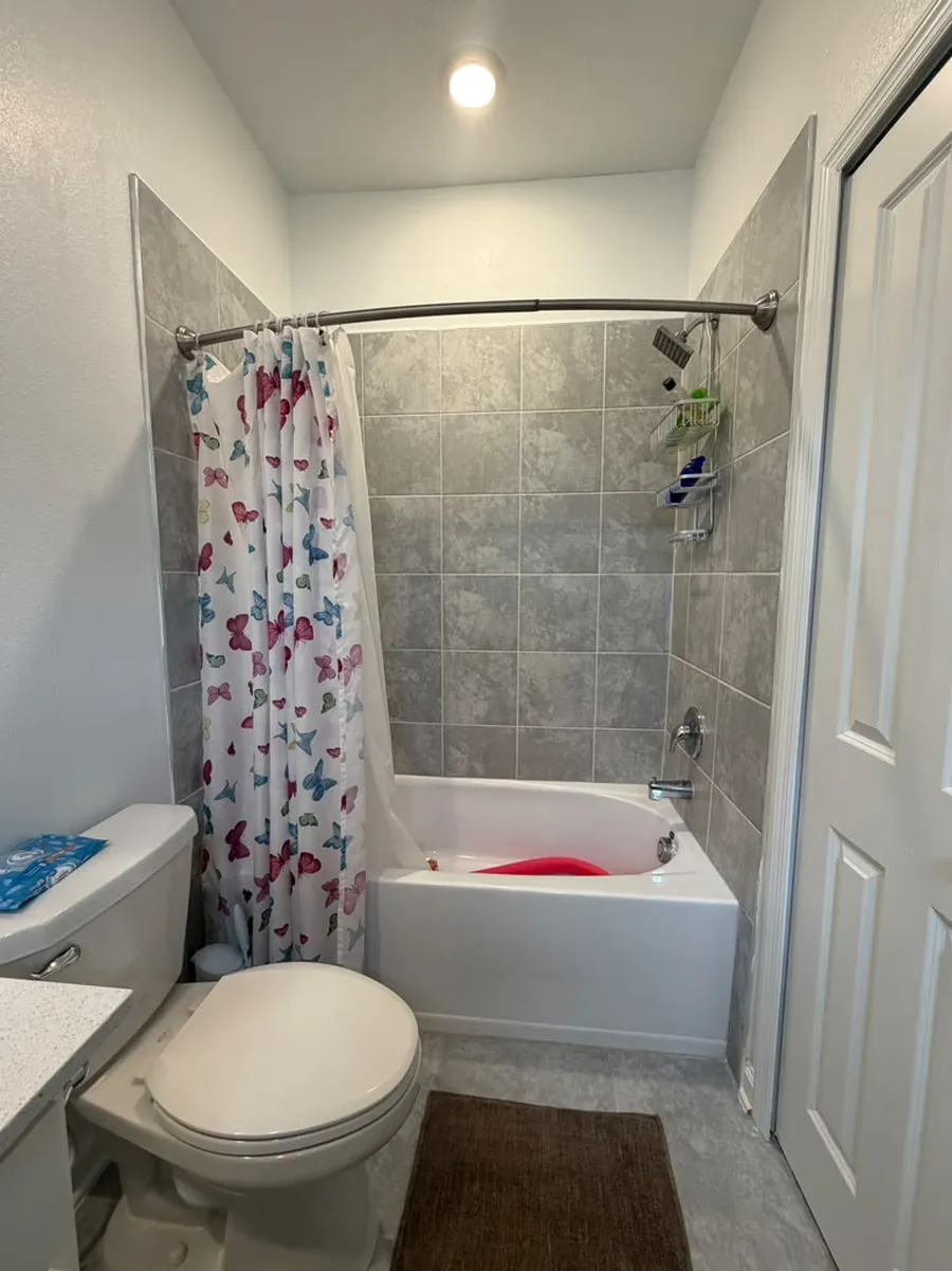 Before: tub with shower curtain in Kissimmee